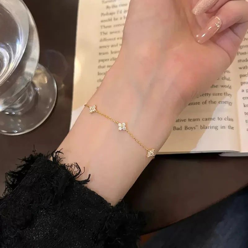 Armband Linn (fyrklöver-armband i guldfärg med zirkoner)