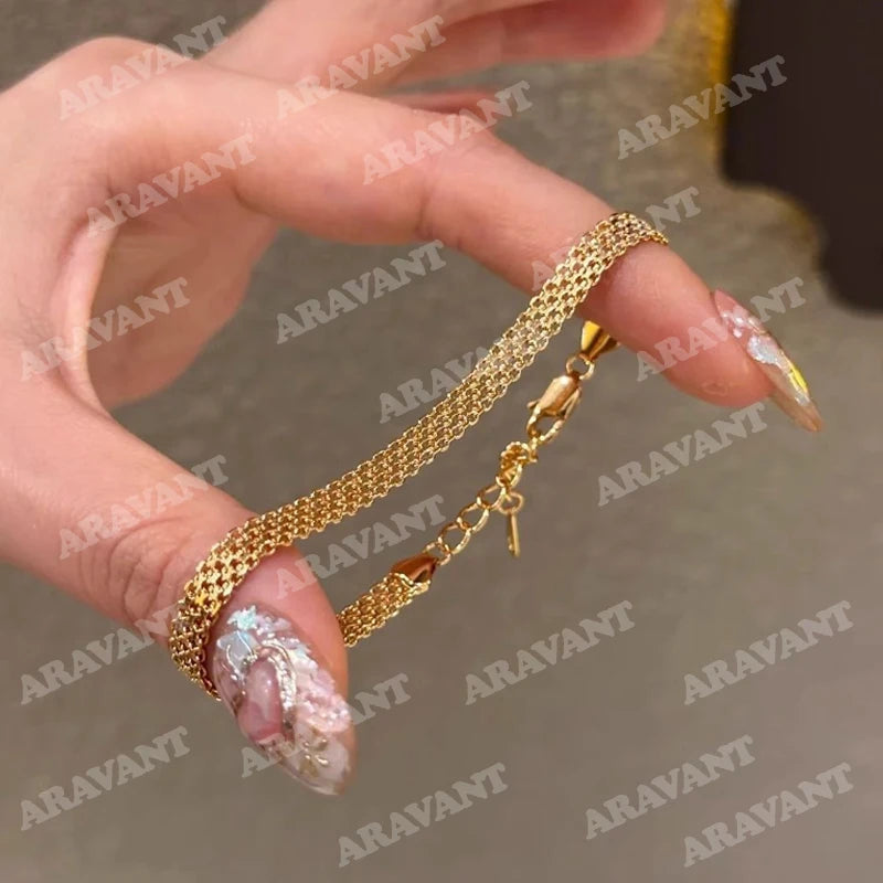 Armband Nora (armbandskedja i klockrem-design – silver & guldfärg)