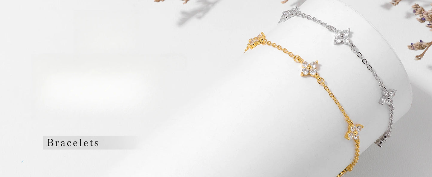 Armband Linn (fyrklöver-armband i guldfärg med zirkoner)
