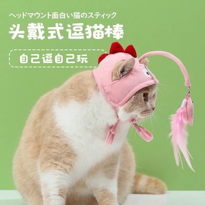 Kissanlelu höyhenillä ja pääkappaleella – Itseaktivoituva leikki