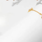 Armband Linn (fyrklöver-armband i guldfärg med zirkoner)